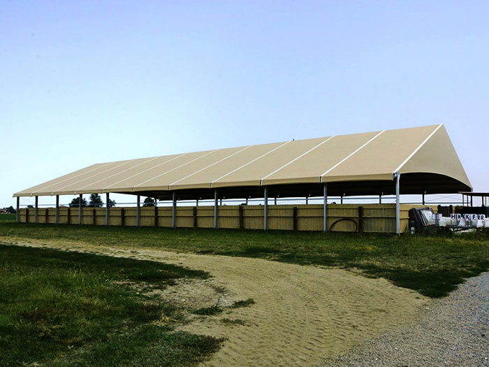 Tensile fabric shade structure for livestock farm