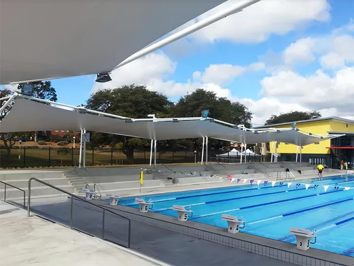 Tensile membrane structure building for pool seating area