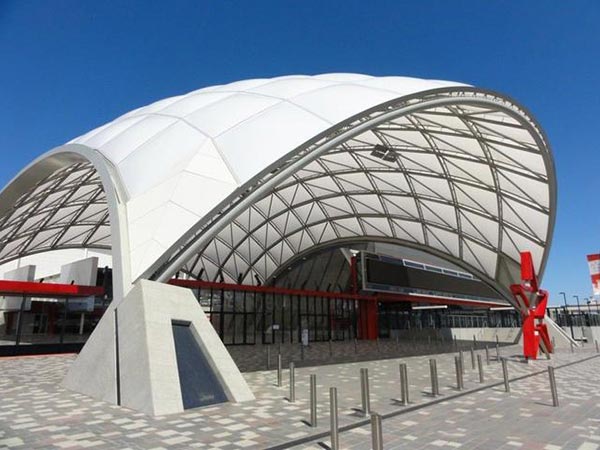 What are the advantages of tensile structure buildings in terms of energy conservation?